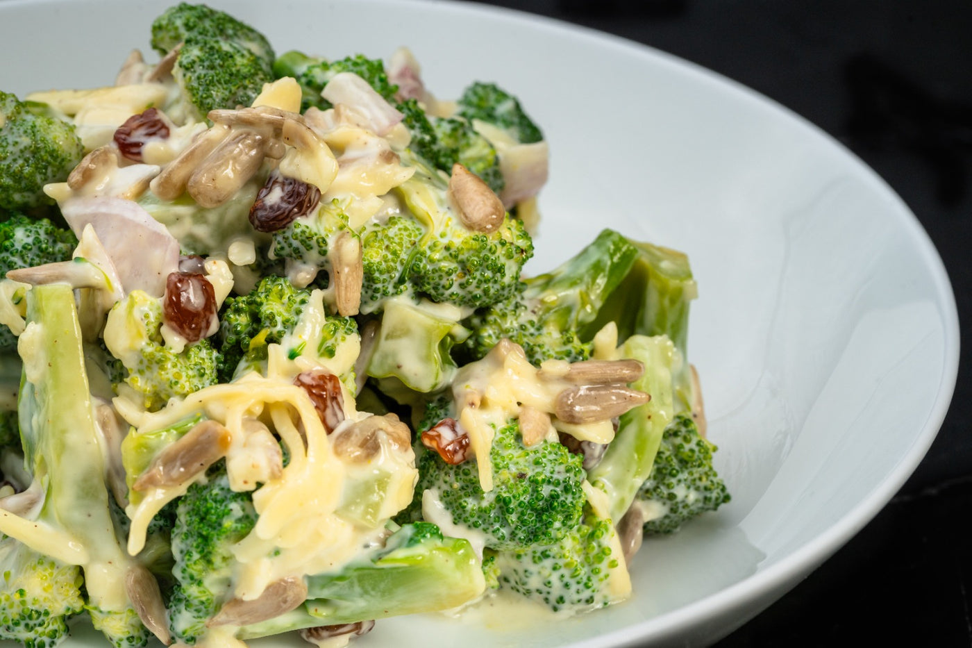 Broc to the Future by Loafology Bakery & Café features a broccoli salad with creamy dressing, raisins, sunflower seeds, chopped onions, and a sprinkle of cheese.