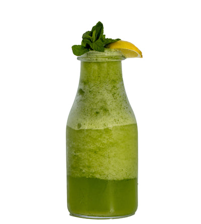 A bottle of Mint Margarita by Loafology Bakery & Café, garnished with organic mint and a lemon wedge on top, isolated on a white background.